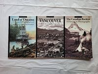 Front covers of three hardcover historical photograph books: Land of Dreams, Vancouver, The Canadian Rockies
