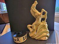 Mid century prancing horse TV lamp and vintage Tupperware box together on dark background