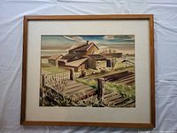 Framed watercolour showing full painting of rural buildings and landscape