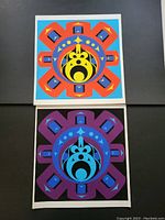 Pair of unframed colorful geometric prints titled "Sun" (top) and "Moon" (bottom) on black background.