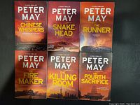Photo showing all six books in the 'A China Thriller' series by Peter May arranged in two rows of three books each with the front covers clearly visible.