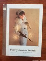 Front cover of 1965 Simpsons-Sears Fall Winter catalog showing woman in blue coat with fur collar, brown gloves, headband, holding dog leash