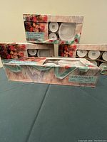 Boxed sets of 12-piece coffee sets showing cups and saucers in floral decorated packaging.