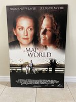 Mounted movie poster featuring Sigourney Weaver and Julianne Moore for the film 'A Map of the World'.