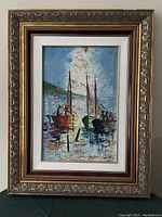 Full view of painting showing sailboats on water with clouds and other boats in the background, framed in ornate gold-colored frame with white and maroon mats.