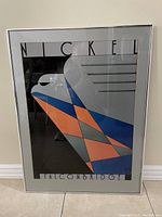 Full frontal image of vintage framed Art Deco poster showing abstract geometric design and text