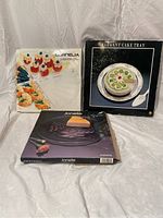 Three boxes of glass platters displayed together, showing the original packaging and condition of each.