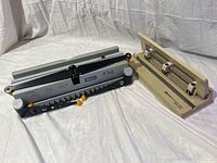 Photo of Ibico Hi Tech wire book binder and Hunt Boston 1531 hole punch side by side on white cloth background.