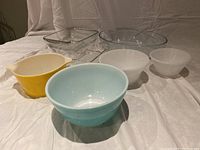 Photo showing all items together: clear Marinex glass oval, square, rectangular baking dishes; colored Pyrex bowls in blue and yellow; two white milk glass bowls