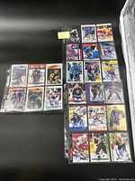 Two pages of plastic protector sleeves showing a total of 18 signed NHL hockey cards in excellent condition, each card signed by a different player.