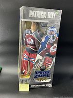Full front view of the Patrick Roy collector doll in original packaging showing the figure and box details.