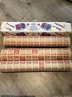 Three rolled uncut hockey card sheets laid out on floor next to original box