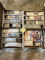 Four large hobby boxes filled with sports cards organized in rows.