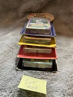 Stack of sealed baseball card sets with visible original packaging and a note labeled 'Lot #24' in front.