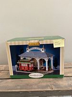 Box front showcasing Lemax Trolley Station building with red trolley and Christmas decorations.