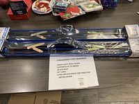 Two blue Mastercraft steel sawhorses packaged in plastic wrap, showing folded legs and frame.