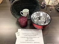Overview of all lot items including the bowl, candle, mug, two ornaments on stand, and basket