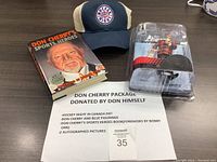 Full view of all items in the Don Cherry package including book, cap, figurine with dog Blue, and printed description sheet.