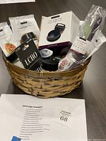 Wicker basket filled with various Epicure seasoning bottles and pouches, a 3-in-1 burger press box, a basting brush, and an LCBO gift card.
