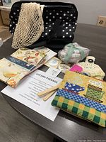 Overview of kitchen package laid out showing thermal carrier, towels, mitts, pot holders, and eco bag