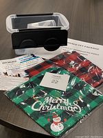 Photo showing the plastic tote, dog bandanas packaged, and gift voucher with information sheet