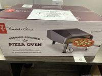 Front of sealed product box showing branding and oven image