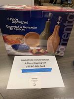 Box of Signature Housewares 6 Piece Dipping Set with image showing bottles and dipping bowls and $25 PC gift card and auction number 5