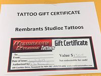 Clear image of the full tattoo gift certificate showing value, date issued, and branding.