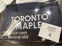 Front view of packaged Toronto Maple Leaf car seat cover showing branding and material details