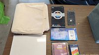Lot contents on table including canvases, art papers, and art mediums