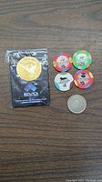 Lot contents: EVO Championship Series 2017 limited edition coin sealed in packaging, six casino chips of various denominations and designs (including PonteXX $25 and $5 chips, $1 chip with horse logo) and a silver casino coin or token.