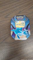 Metal Pokemon-themed storage tin featuring Latios, closed.