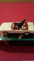 Full side view of the white 1966 Mustang convertible ornament with Christmas tree on the seat and original box underneath