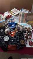 Wide angle showing the general collection including NHL figurines, magazines, signed cloth, baseball, puck and cards