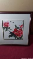 Full view of framed Chinese watercolor painting with pink and red peonies and butterflies.