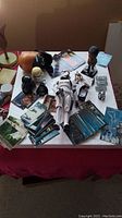 Overall collection of assorted Star Wars collectibles including figures, cards, and memorabilia displayed on a table