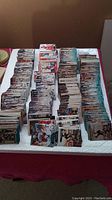 Wide shot of multiple stacks of vintage hockey cards and some other sports cards laid out on a table