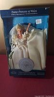 Photo of the Princess Diana doll in original blue Royal Britannia Collection box, wearing wedding dress with long train.
