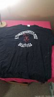 Full view of vintage The Tragically Hip black T-shirt laid flat showing front graphic and text
