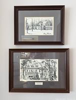 Two framed black and white ink drawings hung on a white wall, one above the other. The top depicts Olney Theatre while the bottom shows The Pittock Mansion with a metal plaque below the drawing.