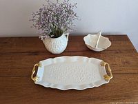 Set of three Lenox pieces on wooden surface: tray, small basket, and vase with floral accents