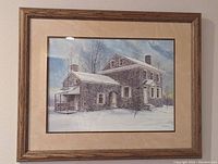 Photo of a framed watercolor painting depicting a stone house in snowy Valley Forge by Peter Sculthorpe