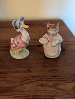 Front view of Jemima Puddleduck and Mrs Ribby figurines showing detailed hand-painted features.