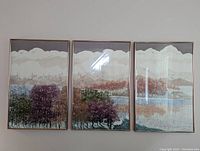 Photo showing the triptych set of three framed Russa Graeme fine art etchings of a North Woods landscape hung on a wall.