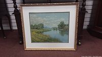 Full view of framed landscape print with ornate gold frame and glass.