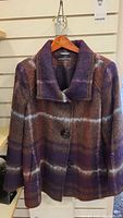 Front view of purple plaid jacket on hanger showing pattern, collar, and buttons.