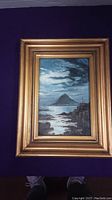 Photo of original acrylic painting showing full artwork and gilt frame on dark background.