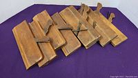 Top view of seven vintage wooden profile planes showing shape and condition