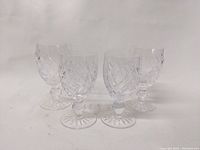 Four Waterford crystal stem glasses with Donegal pattern shown on white background.