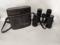 Bushnell Sportview 7x35 binoculars with case shown together on white background.